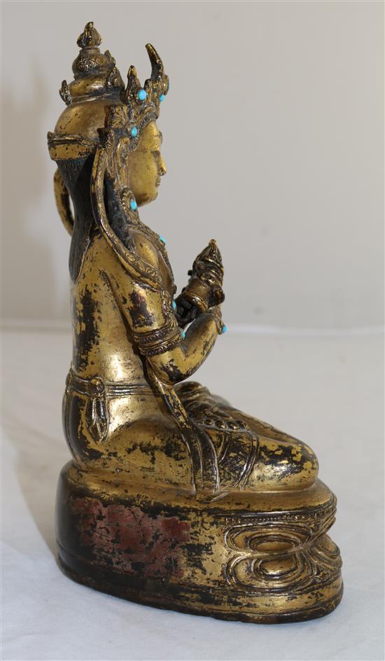 A Nepalese gilt copper alloy jewelled figure of Vajradhara, early Malla period, 15th century, height 20.3cm, later paste and stone ca